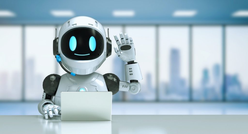 Robot souriant assis devant un ordinateur portable dans un bureau